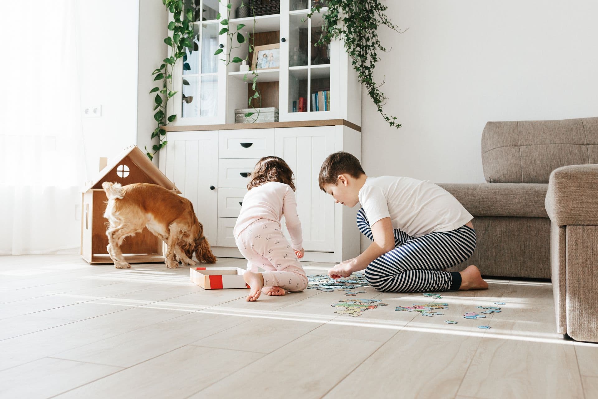 Kids playing on floor with dog